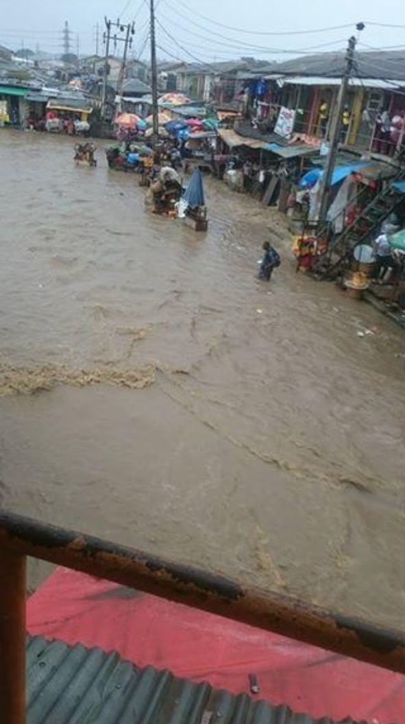 Vehicles stranded on flooded Ikotun road